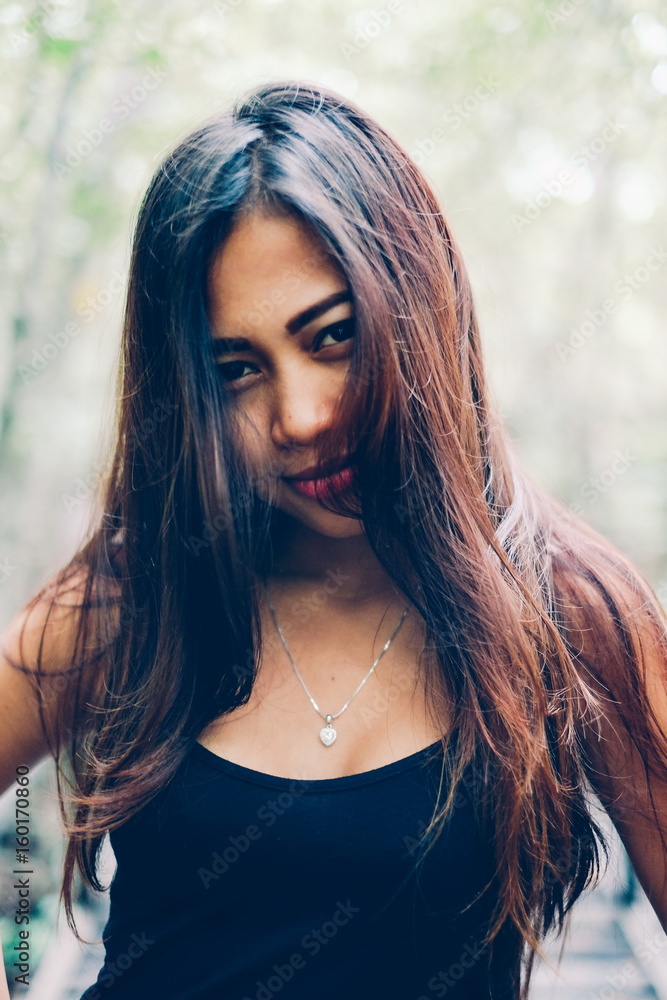 Naklejka premium Young beautiful girl portrait on the wooden bridge in the mangrove forest