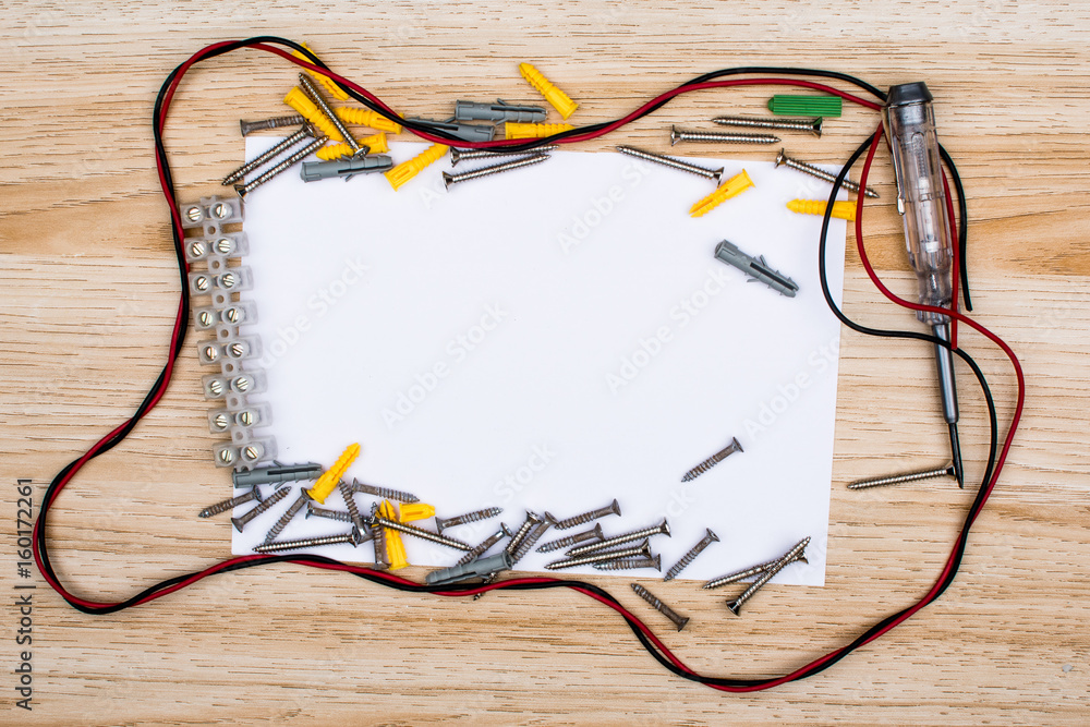 wire, screw and empty sheet of paper. Studio shot on wooden background. Fathers day composition wire, screw and empty sheet of paper. Studio shot on wooden background. Fathers day composition