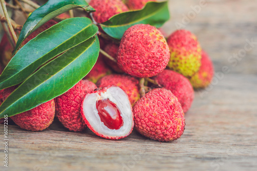 Fresh litchi fruit on an old wooden background photo