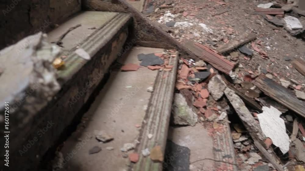 CLOSE UP: Detail of cracked stone steps and collapsing ruined staircase in abandoned decaying mansion. Broken stairs in the corridor of crumbling industrial building. Dirt and rubble on rock stairway CLOSE UP: Detail of cracked stone steps and collapsing ruined staircase in abandoned decaying mansion. Broken stairs in the corridor of crumbling industrial building. Dirt and rubble on rock stairway