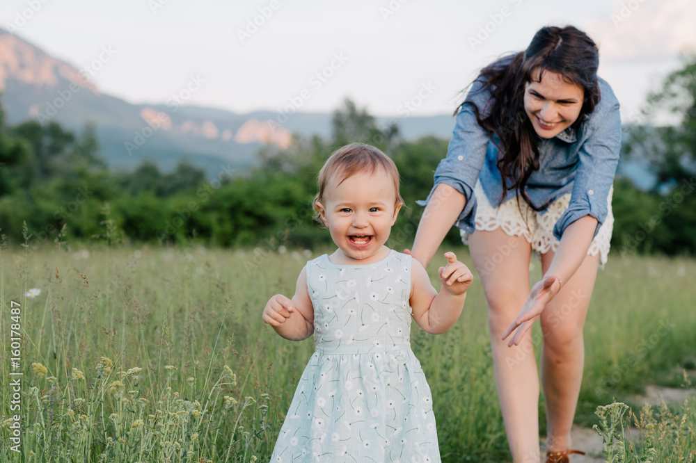 Happy young mother with baby girl walking outside. Happy young mother with baby girl walking outside.