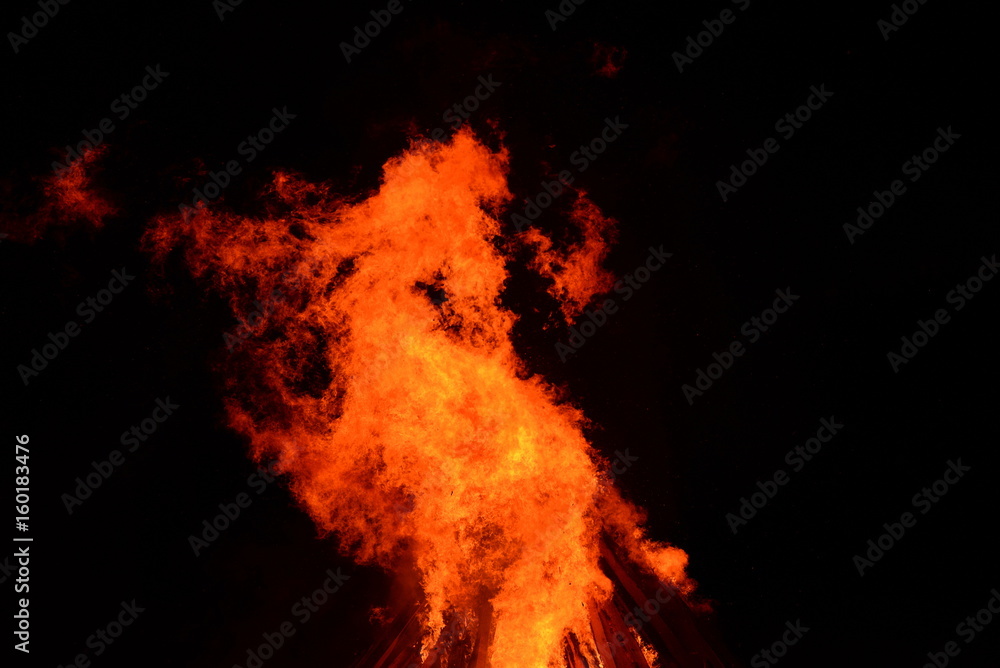 Feuerdrache, wild loderndes Feuer vorm Nachthimmel