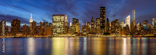 Panoramic view of Midtown East skyscrapers from the East River at twilight. Manhattan, New York City photo