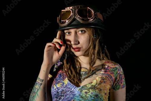 Female gothic warrior in pilot old glasses posing with katana sword © sandyche