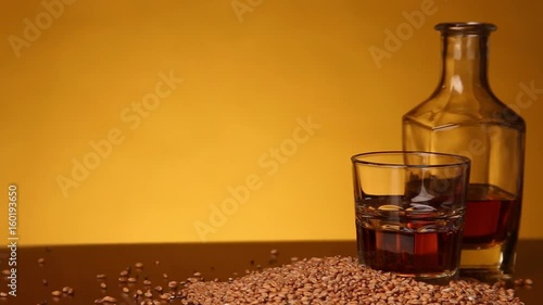 Whiskey or bourbon or skotch and corn on the table. camera movement from left to right photo