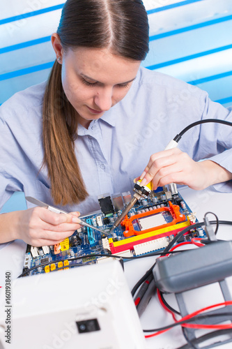 Wallpaper Mural Young woman fix PC component in service center Torontodigital.ca