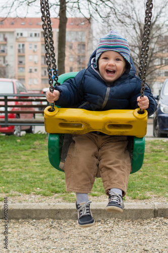 Happy child on swing