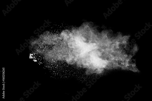 White powder explosion isolated on black background