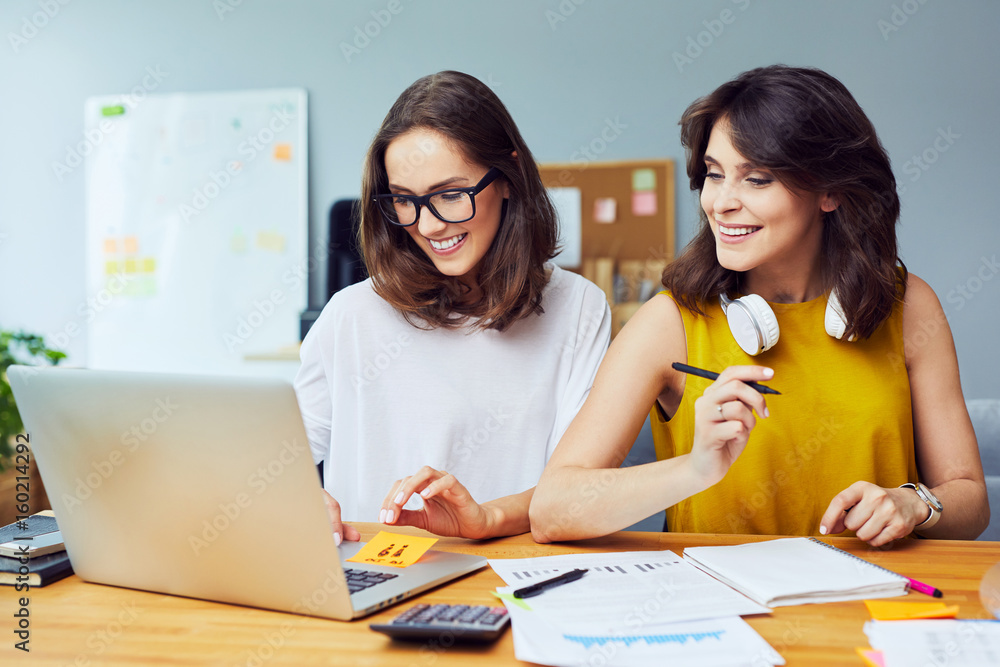 Two Successful business women collaborating in office Two Successful business women collaborating in office