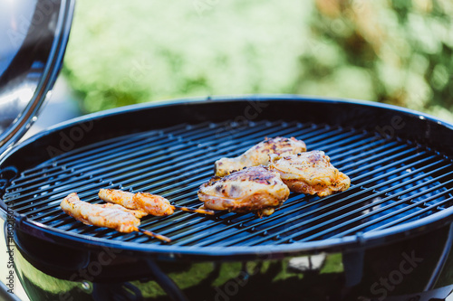 Chicken on grill cooking grate