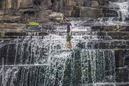 Man hiker, tourist on the background of Amazing Pongour Waterfall is famous and most beautiful of fall in Vietnam. Not far from Dalat city estimate 45 Km. Dalat, Vietnam photo