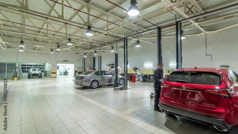 Cars moves on lifts in modern service station and men repair cars timelapse hyperlapse. Cars moves on lifts in modern service station and men repair cars timelapse hyperlapse.