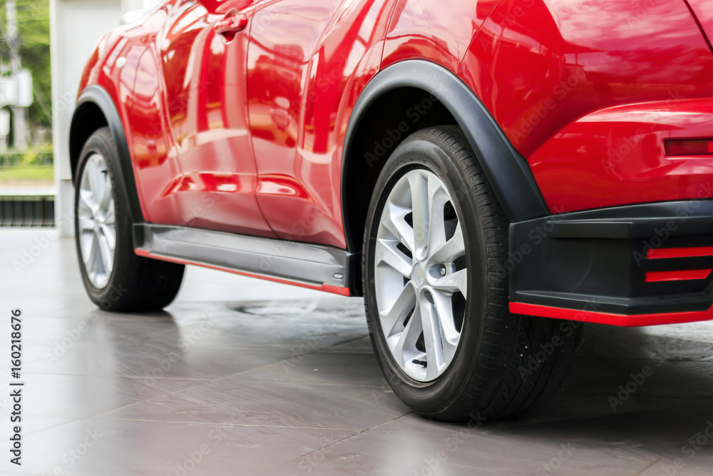 closeup red car with soft-focus in the background and over light closeup red car with soft-focus in the background and over light