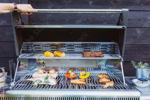 Barbecue grill station otdoor with fish, sausages, meat photo