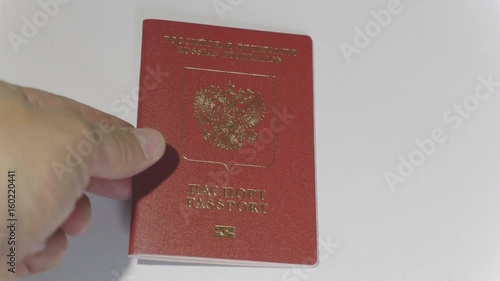 MOSCOW, RUSSIA, JUNE 3, 2017: Taking passport of the citizen of the Russian Federation. Passport is a document certifies the identity of its holder for the purpose of international travel. photo