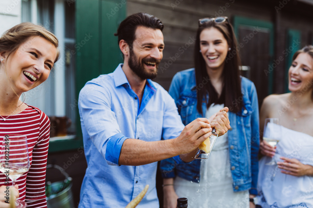 Man grates parmesan on salad at barbecue with friends Man grates parmesan on salad at barbecue with friends