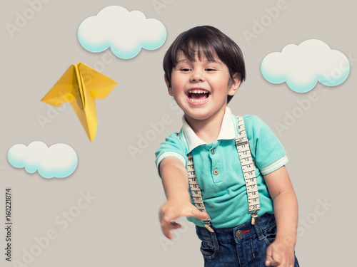 The boy is launching a paper plane