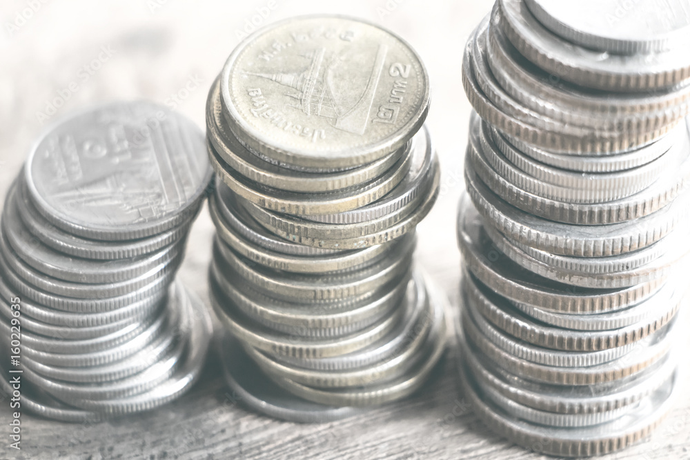 Row of coins on wood background for finance and Saving concept,Investment, Economy, Soft focus and dark style. Row of coins on wood background for finance and Saving concept,Investment, Economy, Soft focus and dark style.