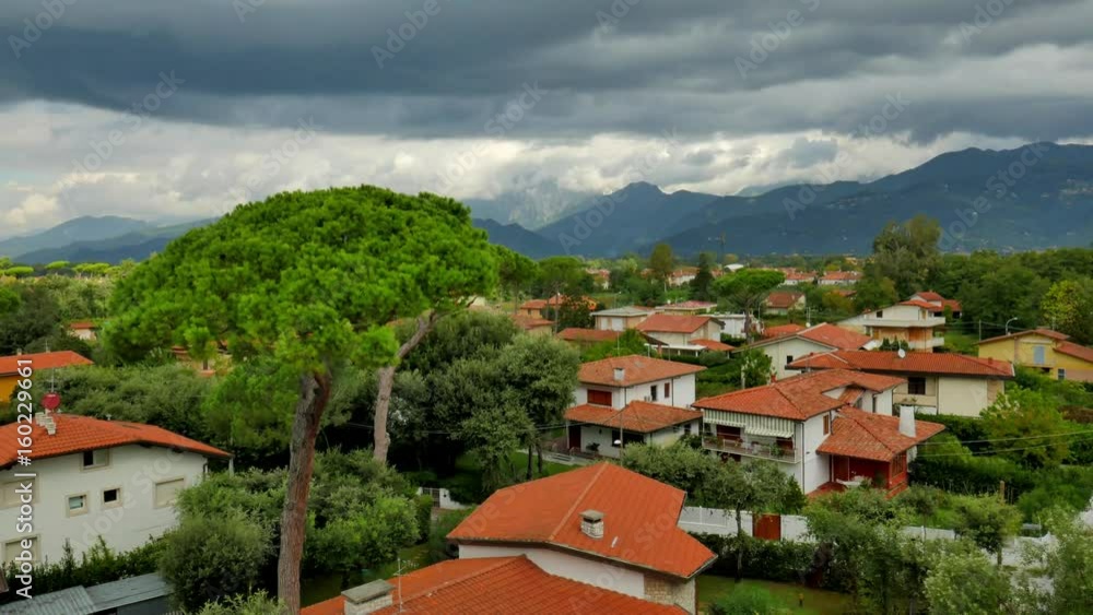 TIME LAPSE Stormy clouds rolling in on the sky over the beautiful landscape of the suburbs with beautiful houses and green tall trees. Italy, Tuscany TIME LAPSE Stormy clouds rolling in on the sky over the beautiful landscape of the suburbs with beautiful houses and green tall trees. Italy, Tuscany