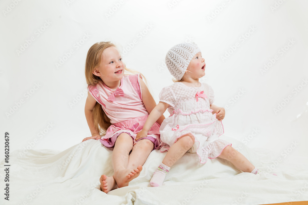 two little girls sit two little girls sit