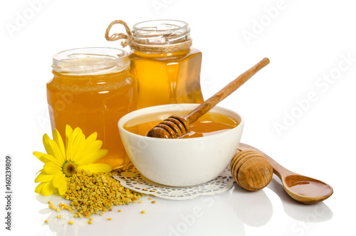 Yellow flower and bee products (honey, pollen) isolated on white background