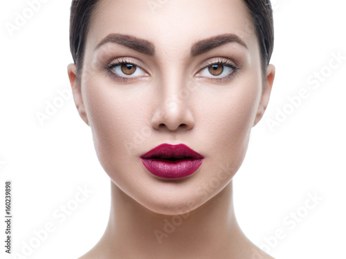 Beauty girl face portrait isolated on white. Model woman with perfect makeup looking at camera