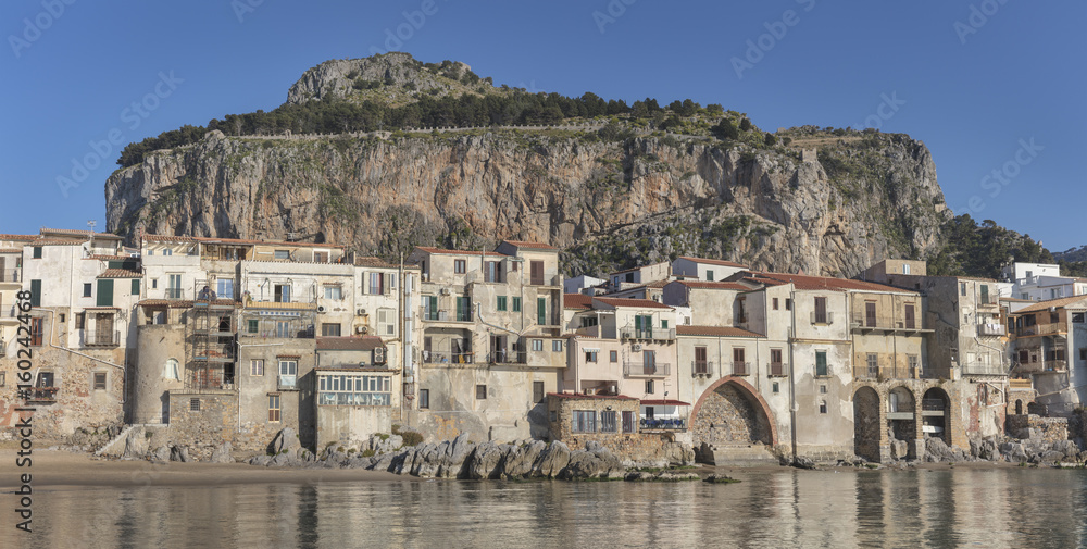 Old medieval town Cefalu with mountain La Rocca in background, Sicily, Italy