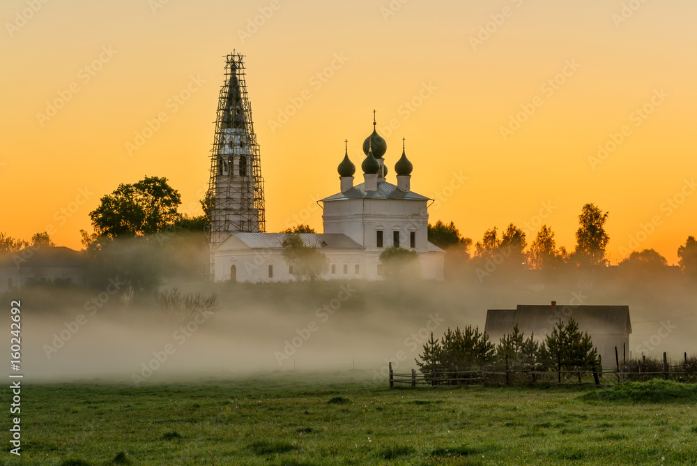 Misty morning overlooking the Kazan Church and the Church of St. John the Warrior in the village of Osenevo, Gavrilov-yamskiy district of the Yaroslavl region
