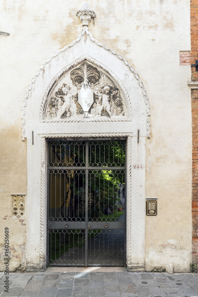 Venice, Veneto / Italy- May 20, 2017: Typical Venetian portal on the street called 