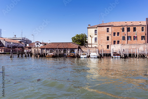 Venice, Veneto / Italy- May 20, 2017: Industrial buildings on the canal to the sea of venice © peizais