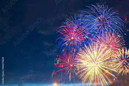 Fireworks of various colors bursting against a black