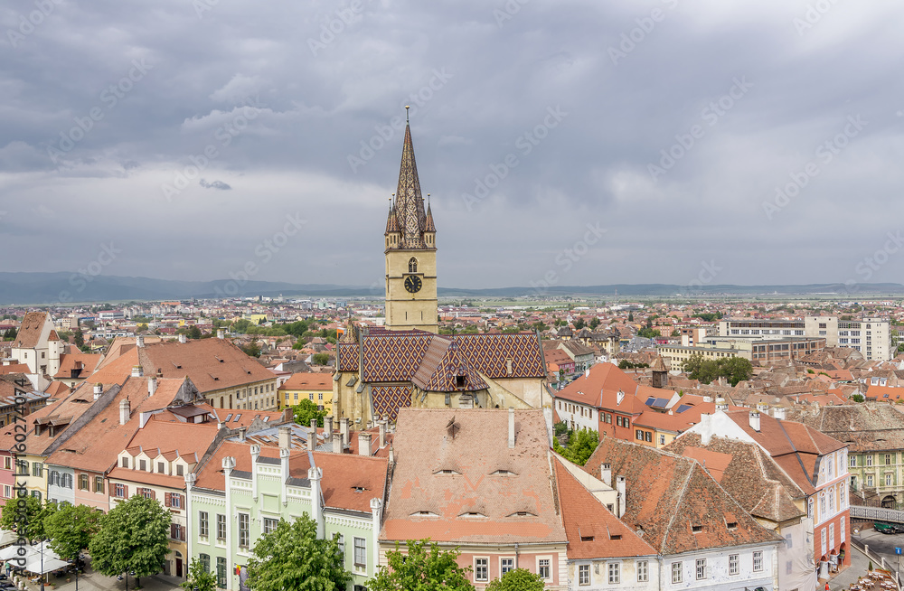 Breathtaking aerial view on the famous Piata Mica, Small Square, from the top of the Council Tower, in the historic center of Sibiu, Romania, with the Saint Mary Cathedral in the background