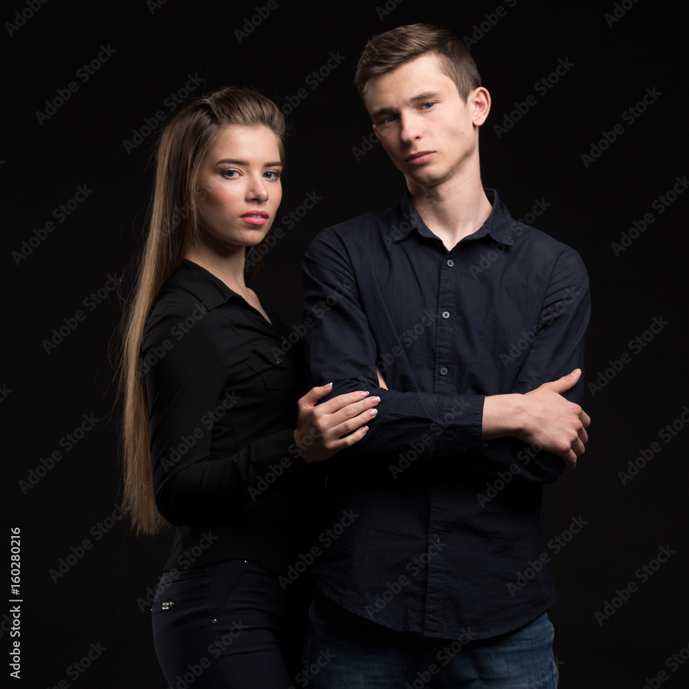 Young happy couple showing presentation pointing on placard over Young happy couple showing presentation pointing on placard over