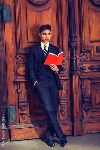 Young Indonesian American Man reading book in New York