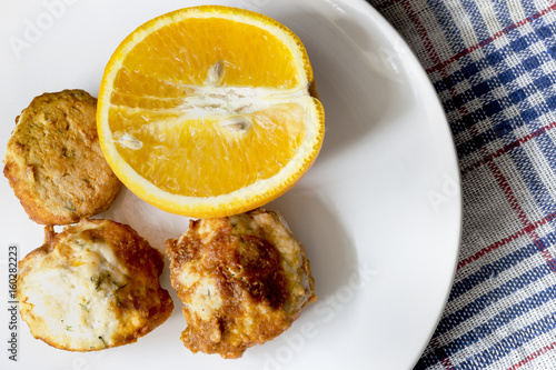 Meatballs with chicken and orange on a white plate