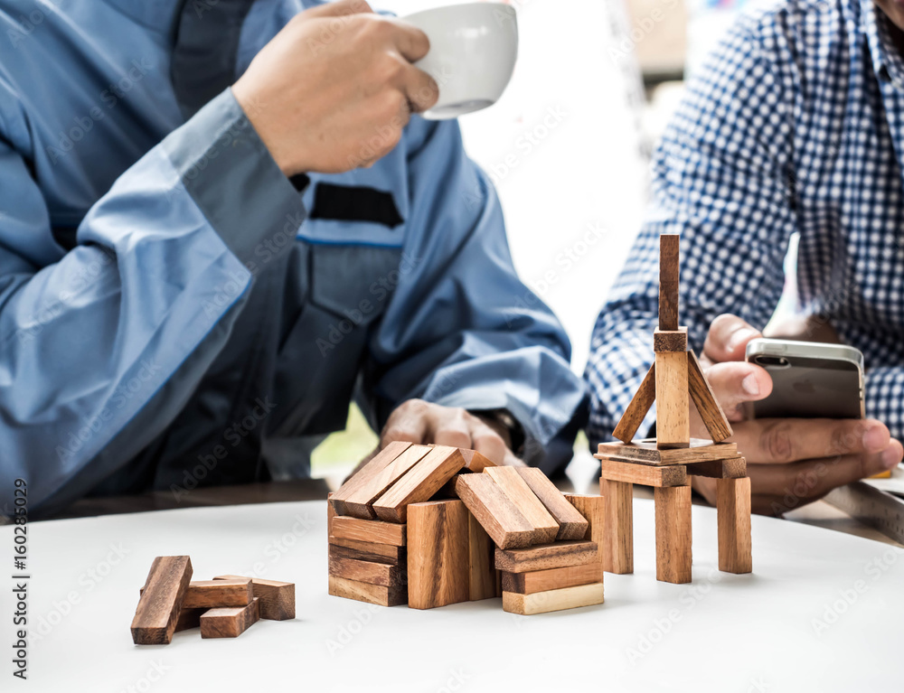 Close Up of business team making a structure with wooden cubes. Building a business concept. Close Up of business team making a structure with wooden cubes. Building a business concept.