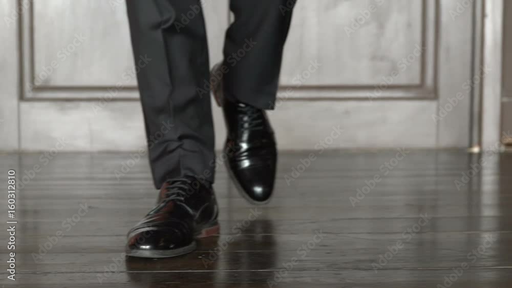 Unrecognizable businessman walking in the office. Slow motion Unrecognizable businessman walking in the office. Slow motion
