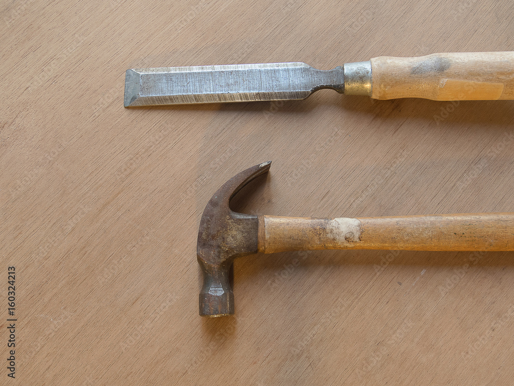 Carpenter's tools, Hammer and chisel on wooden table bottom