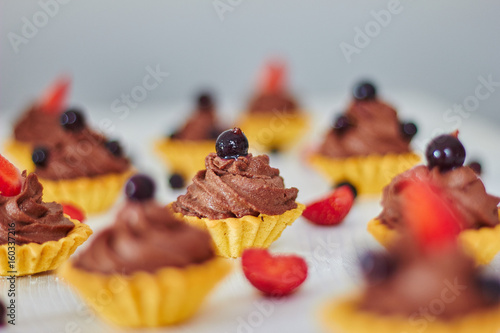 chocolate cupcakes with strawberries and blackcurrant