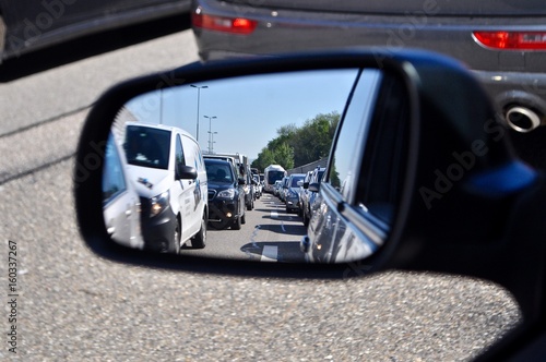 Autostau - Blick aus dem Rückspiegel auf  wartende Autos - Autokolonne / Autoschlange 