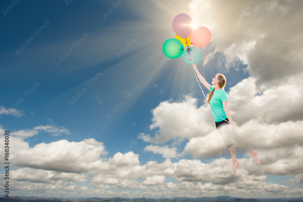 Young Adult Female Being Carried Up and Away Into The Clouds By Balloons That She Is Holding. Young Adult Female Being Carried Up and Away Into The Clouds By Balloons That She Is Holding.