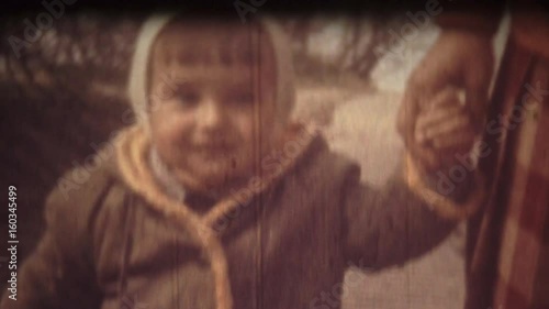 Family Chronicle: Happy mother and son holding hands walking in city park
