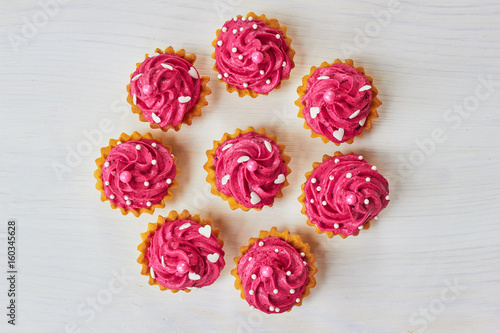 Pink cupcakes decorated with pearls and hearts