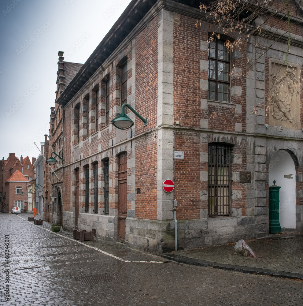 Traditional brick building exterior with focus on street corner, Belgium.