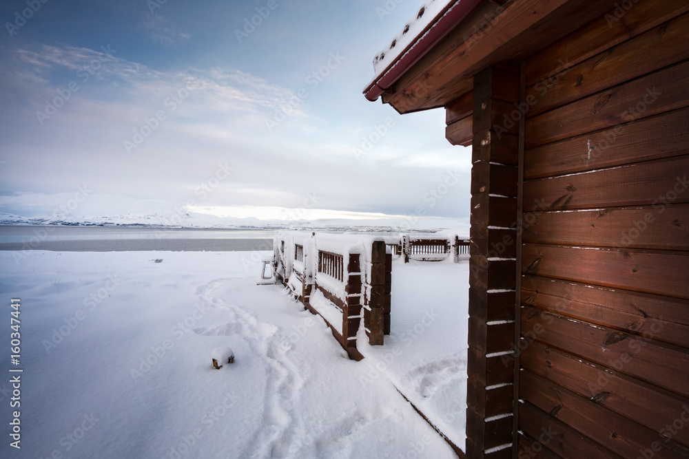 Cosy log cabin retreat in snow covered landscape, Iceland, Europe. Cosy log cabin retreat in snow covered landscape, Iceland, Europe.