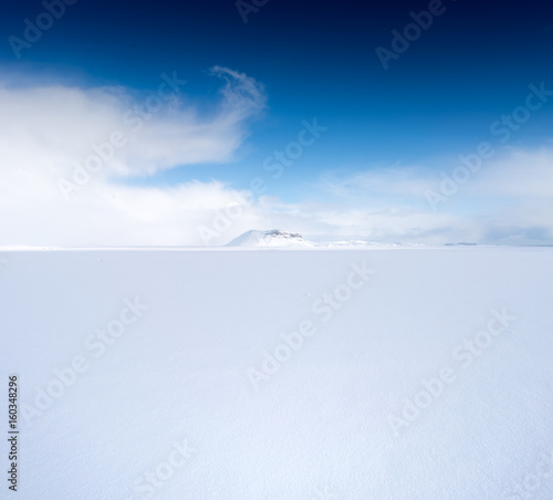 Snow covered landscape, distant mountain and blue sky, Iceland, Europe. © bruno135_406