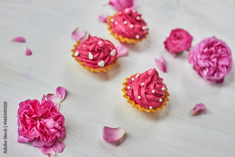 Pink dessert on white wooden table with pink roses Pink dessert on white wooden table with pink roses