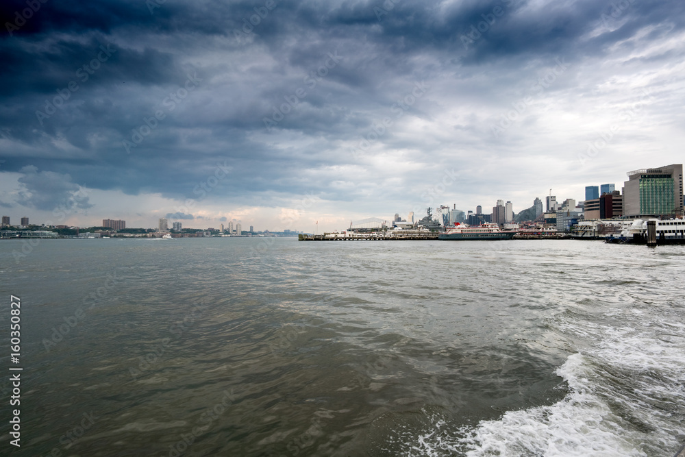 View across water towards the distant buildings, New York, USA.