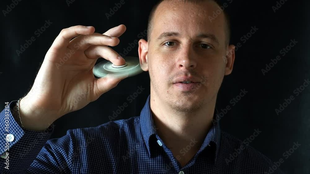 the young man launches into a hand spinner,black background. the young man launches into a hand spinner,black background.