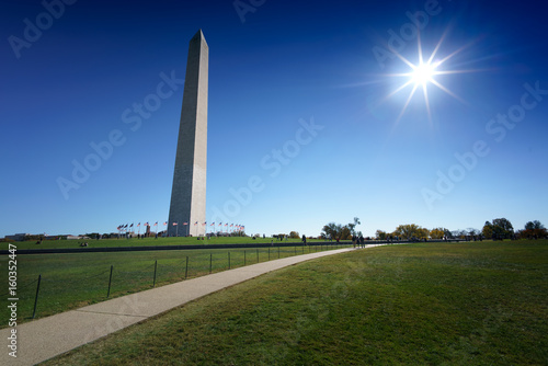 Distant view of Washington obelisk encircled with flags, Washington DC, USA.